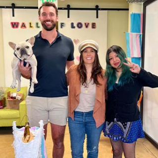 Man and two women pose in an LGBTQ Unicorn Home site