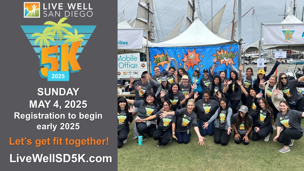 2025 Live Well 5K Website Banner Event May 4, 2025; Registration Early 2025 - Group of race participants gather in front of photo booth for silly picture