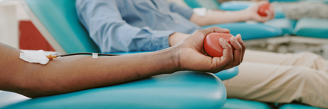 woman donating blood at blood drive